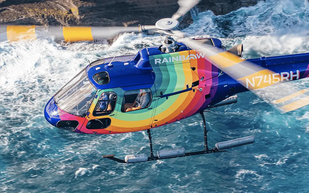 A helicopter over the turquoise reef off the Oahu coast