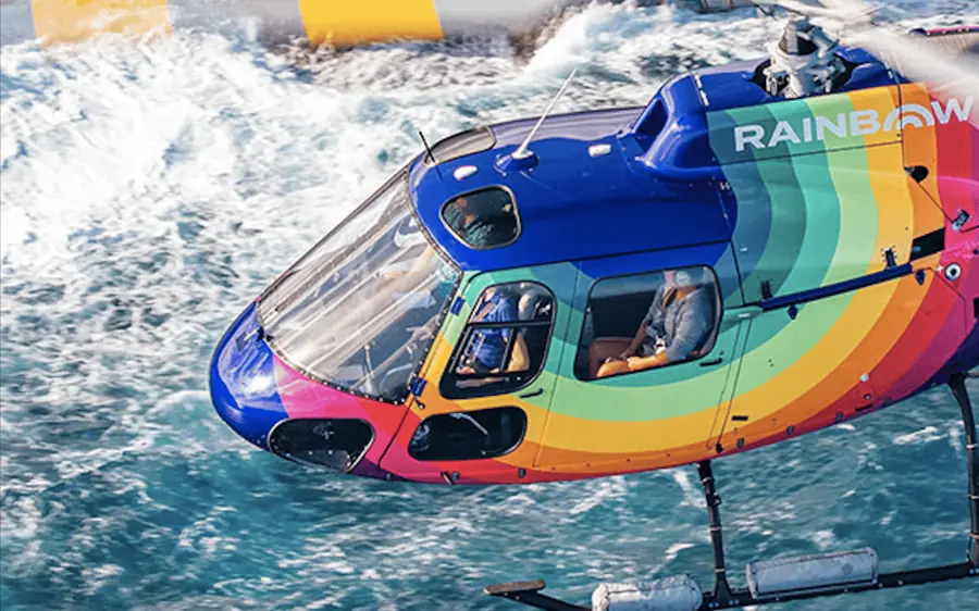 A Rainbow Helicopters aircraft above the Oahu shoreline