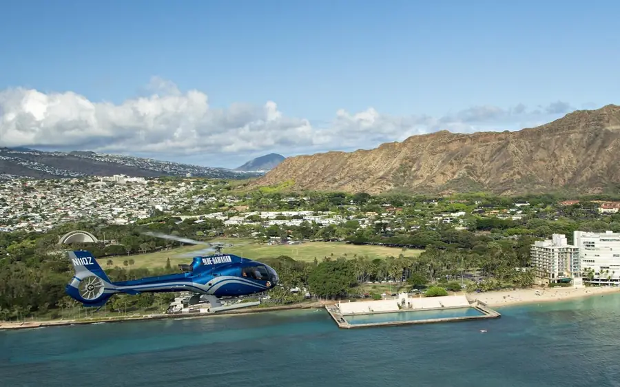 A helicopter over the turquoise reef off Oahu